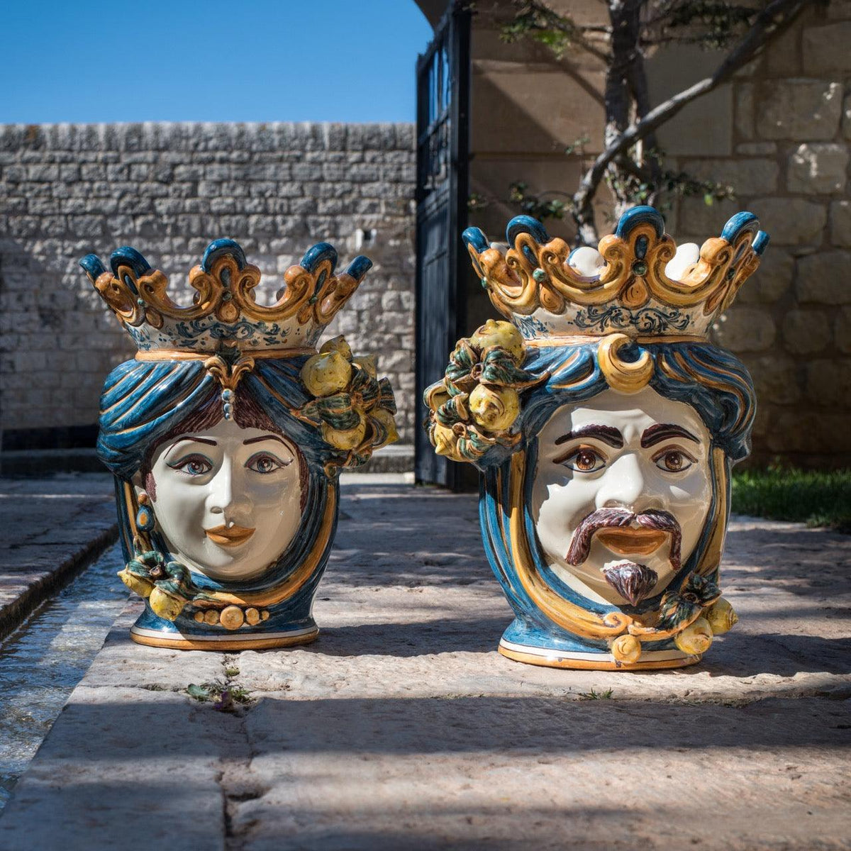 Teste di moro femmina e maschio in ceramica Caltagirone fatti a mano, decoro blu arancio e limoni, artigianato Sicilia.