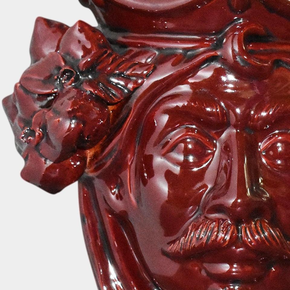 Ceramiche di Caltagirone fatti a mano con volto e fiori in smalto rosso