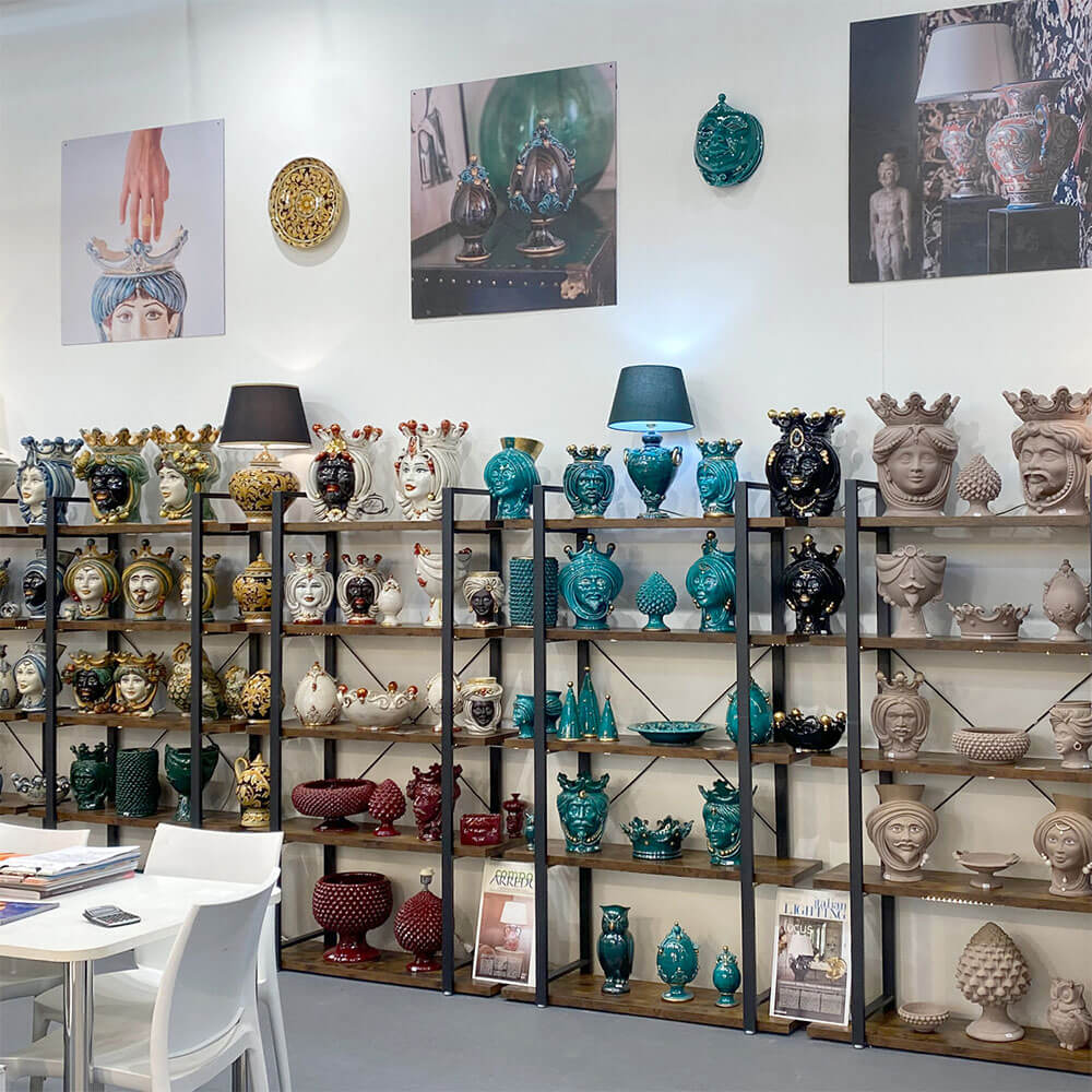 Ceramiche di Caltagirone fatte a mano: teste di moro, vasi e lampade colorati su scaffali