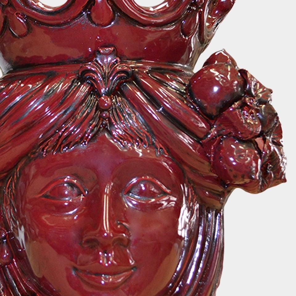 Ceramiche di Caltagirone fatti a mano: volto femminile in terracotta rossa con corona e fiori